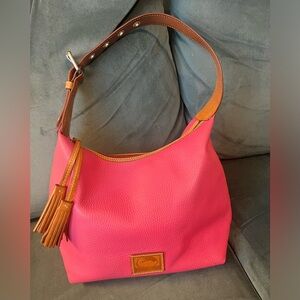 Gorgeous, good condition hot pink Dooney Burke, leather bag with tassel zipper.